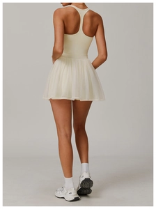 Back view of cream racerback athletic dress with tiered mesh pleats for tennis and golf