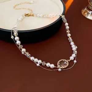 Double-layered geometric faux pearl necklace with brown gemstone and gold chain