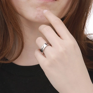 Polished silver stacked ring on model finger showing elegant minimalist jewelry design