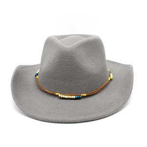 Détail d'un chapeau de cowboy en feutre gris avec cordons en cuir et perles colorées