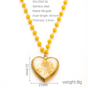 Detail of 18k gold plated heart pendant with dried flowers and yellow beaded chain specs