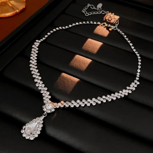 Elegant silver-tone double-row rhinestone necklace with pear-shaped pendant on black leather