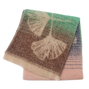 Detail of soft loop yarn scarf with jacquard ginkgo leaf patterns and fringe edges