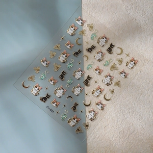 Embossed gold foil cat nail stickers with moon and star designs on sheet Co-531
