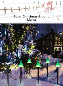 Detailed view of five solar-powered green mini Christmas tree stake lights on snowy ground