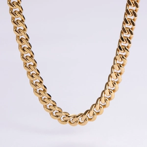 Close-up of polished gold-plated stainless steel Cuban link chain with detailed interlocking