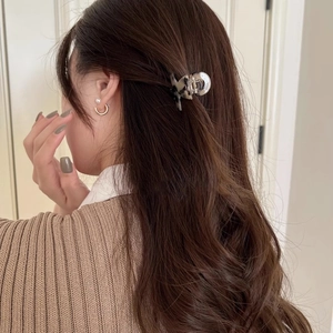 Elegant tortoiseshell texture mini hair claw clip for a stylish half-up ponytail look