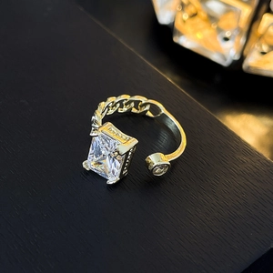 Detail of gold plated Cuban link ring featuring large emerald cut cubic zirconia