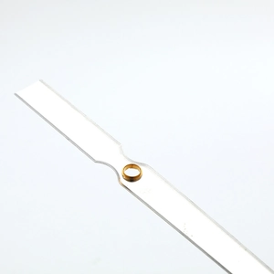 Polished minimalist quartz clock hands with golden center bushing on white background