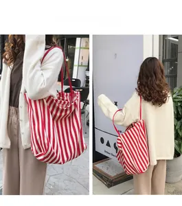 Detail of red and white striped canvas tote bag with slim shoulder straps for daily use