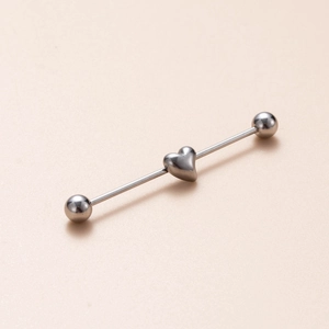 Detail of silver stainless steel industrial barbell with a smooth heart center piece