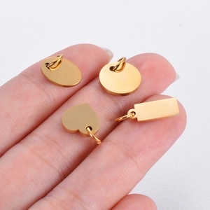 Polished gold stainless steel charms in heart, circle, oval, and rectangle shapes