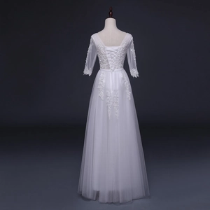 Elegant white lace floor-length evening gown with mesh sleeves and corset back detail