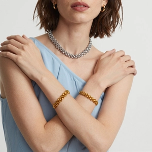 Gold PVD chunky chain necklace and bracelet set with OT buckle on a female model