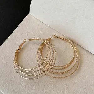 Multi-layered gold geometric hoop earrings with a modern matte finish for women