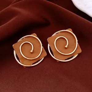 Retro square stud earrings with dark brown enamel and golden spiral metal texture