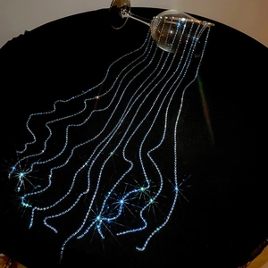 Detailed view of elegant blue rhinestone fringe tassels sparkling on a headband piece