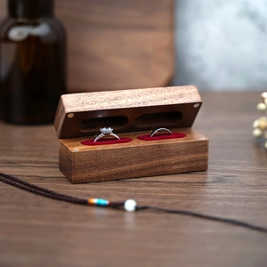 Macro detail of dark walnut ring box with soft red velvet lining and magnetic closure