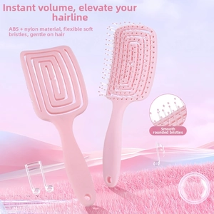 Detail of pink curved vented hair brush with nylon pins and hollow spiral design