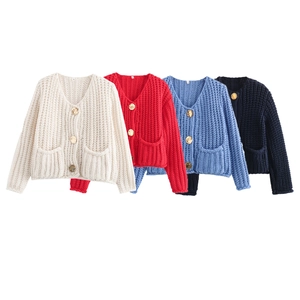 Detail of knit cardigans in multiple colors featuring vintage gold relief buttons
