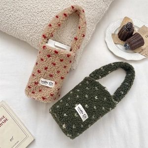 Close-up of heart pattern plush cup carriers in khaki and green faux shearling fabric