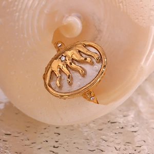 Macro shot of 18K gold plated celestial ring featuring a leopard on white inlay