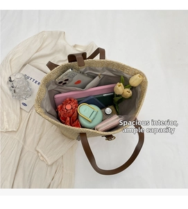 Top view of large straw tote bag showing spacious interior with tablet and umbrella