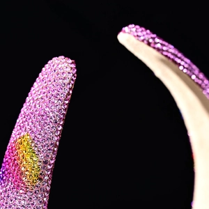 Macro shot of sparkling pink and yellow rhinestones on a luxury sponge headband