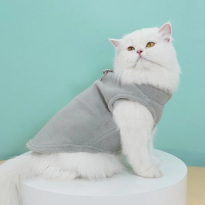 Detail of grey fleece pet vest featuring durable metal D-ring for leash attachment