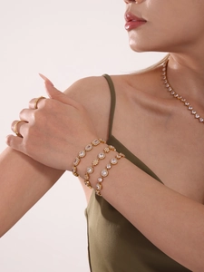Detail of 18K gold-plated bracelets and rings with sparkling cubic zirconia on a model