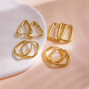 Minimalist 14K gold plated stainless steel geometric earrings set on a ceramic tray