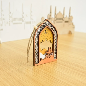 Detail of wooden Islamic hanging ornament featuring carved mosque, stars and moon design