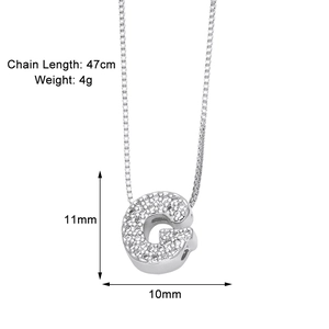 Macro detail of silver G letter pendant with zircon inlay and exact dimensions