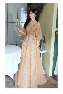 Detail of champagne gold evening gown featuring star-shaped sequins and lantern sleeves