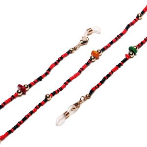 Macro shot of colorful seed beads and natural stones on glasses chain with golden lobster clasp