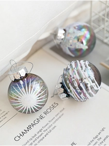 Detailed view of iridescent Christmas ball with white glitter and micro-bead patterns