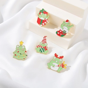 5-piece set of festive Christmas frog enamel pins with gifts and Santa hats on white podium