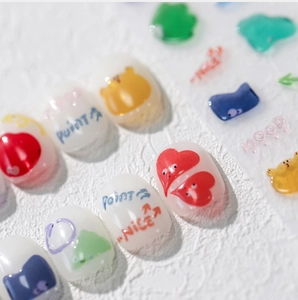 Macro shot of 3D jelly nail art stickers with cute cartoon bears and colorful hearts