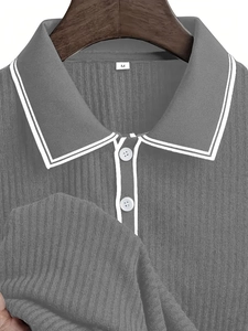 Detailed macro view of grey knit polo collar with white stripes and ribbed texture fabric