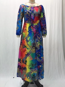 Close-up of colorful baroque and greek key patterns on a long-sleeve maxi dress fabric