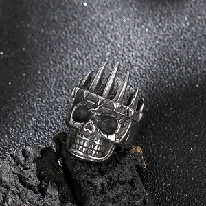 Anello teschio gotico da uomo con corona di spine su roccia scura, design stile rock
