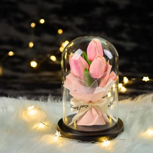 Pink tulip soap flowers in elegant glass dome with warm LED lights and black base
