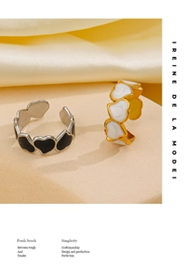 Detail of adjustable heart rings with black and white enamel finish on a beige display