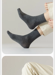Detailed texture of dark grey cotton crew socks worn with beige pants and sneakers