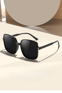 Close-up of square black fashion sunglasses with bold frame on minimalist background