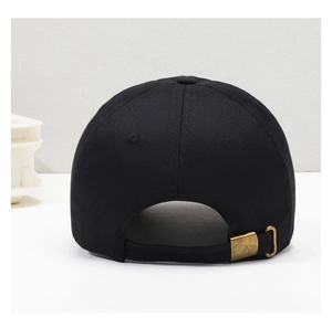 Close-up of black cotton baseball cap showing adjustable brass metal buckle and strap