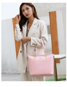 Chic pink PU leather tote bag with gold chain strap styled on a beige blazer outfit
