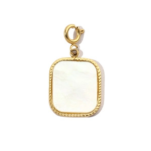 Macro detail of golden square shell pendant with spring clasp and textured border