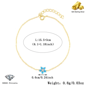 Detail of 925 sterling silver gold bracelet with a floral turquoise and zircon pendant