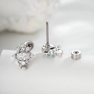 Elegant silver cartilage stud earrings featuring oval zircon stone and tiny pearls